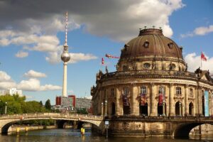 Across the Spree, the domed Old Museum stands beside a bridge, with Berlin TV Tower rising behind it on Museum Island.