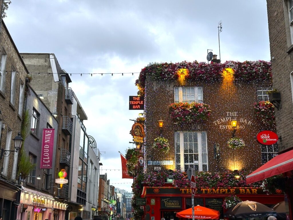 The Temple Bar, a well-known pub in Dublin, decorated with flowers and lights.