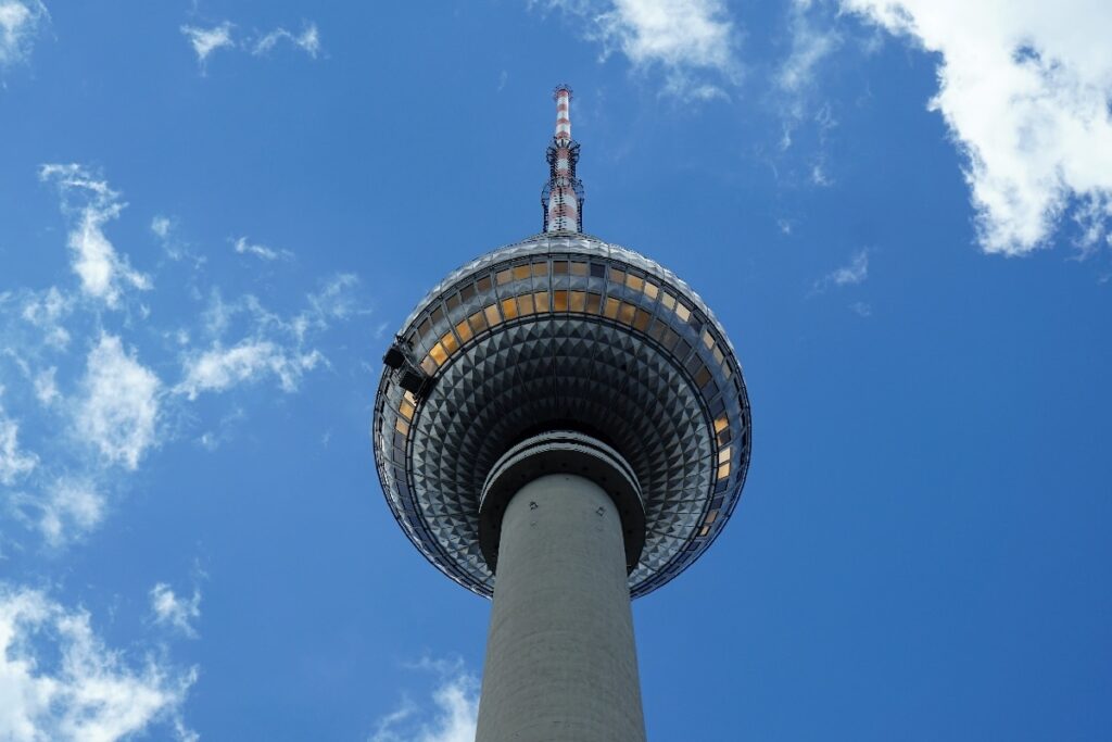 Seen from below against a blue sky, Berlin TV Tower stands out among the top attractions in this guide to Berlin.