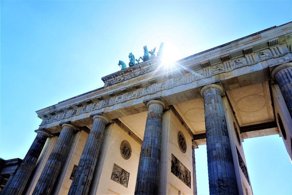 Sunlight glints above the columns and Quadriga of Brandenburg Gate in Berlin, a landmark on a realistic two-day itinerary.