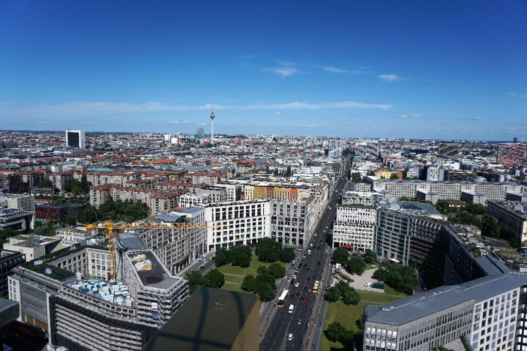 From Panoramapunkt, central Berlin stretches toward the TV Tower, with Potsdamer Platz buildings and busy streets visible below.