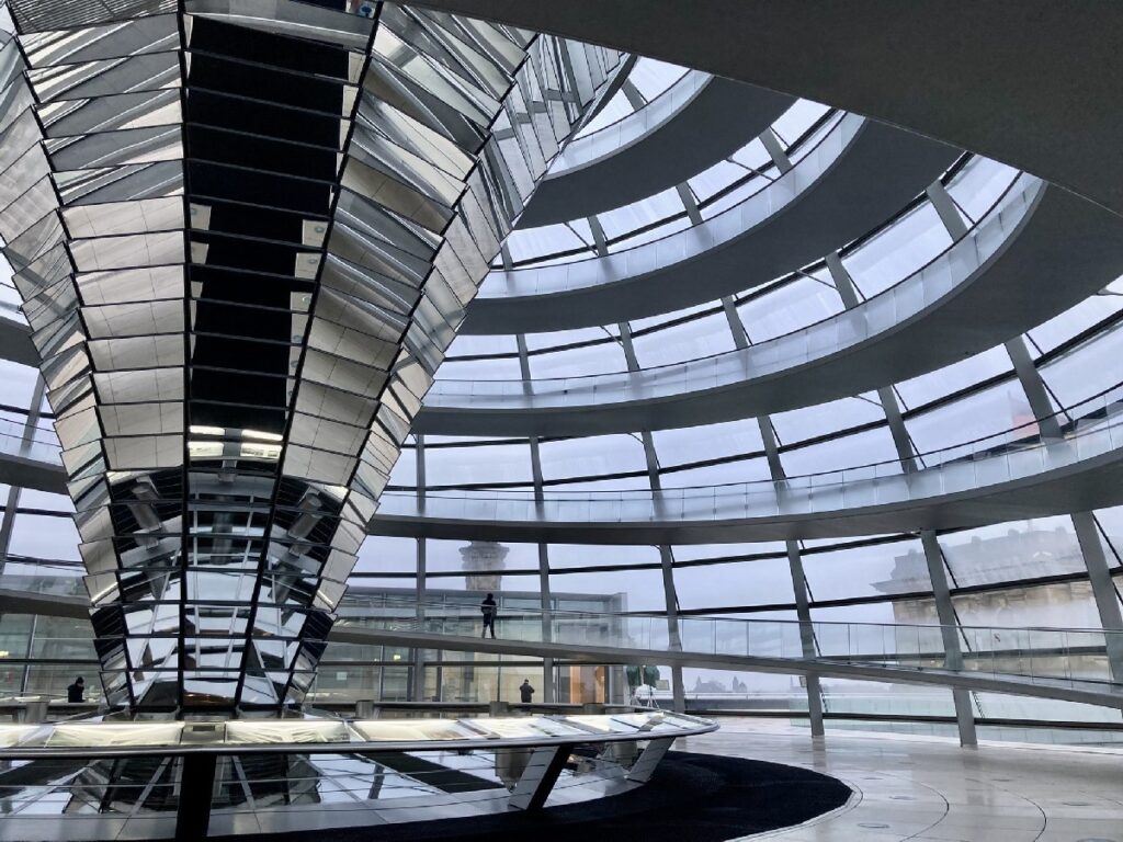 Visitors walk the spiraling glass dome inside Berlin's Reichstag Building, one of the top attractions for sightseeing.