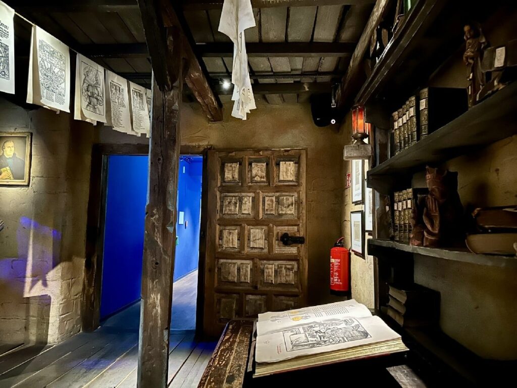 Inside Deutschland Museum, wooden beams, printed historical documents and a heavy paneled door evoke Berlin’s history.