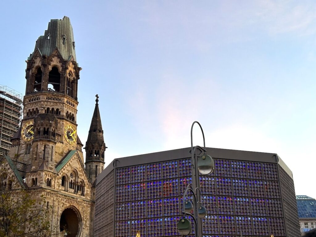 Berlin’s Kaiser Wilhelm Memorial Church and its modern blue-lit church hall mark a stop on a realistic one-day city itinerary.